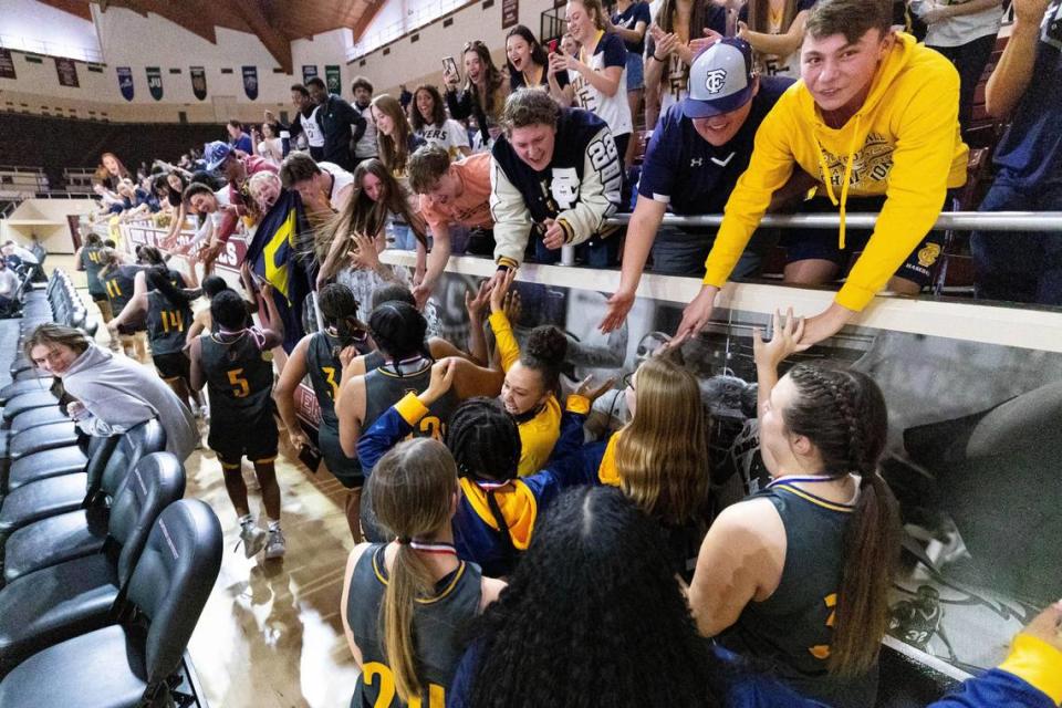 Franklin County players high-five their student section after winning the 11th Region Tournament championship last season.