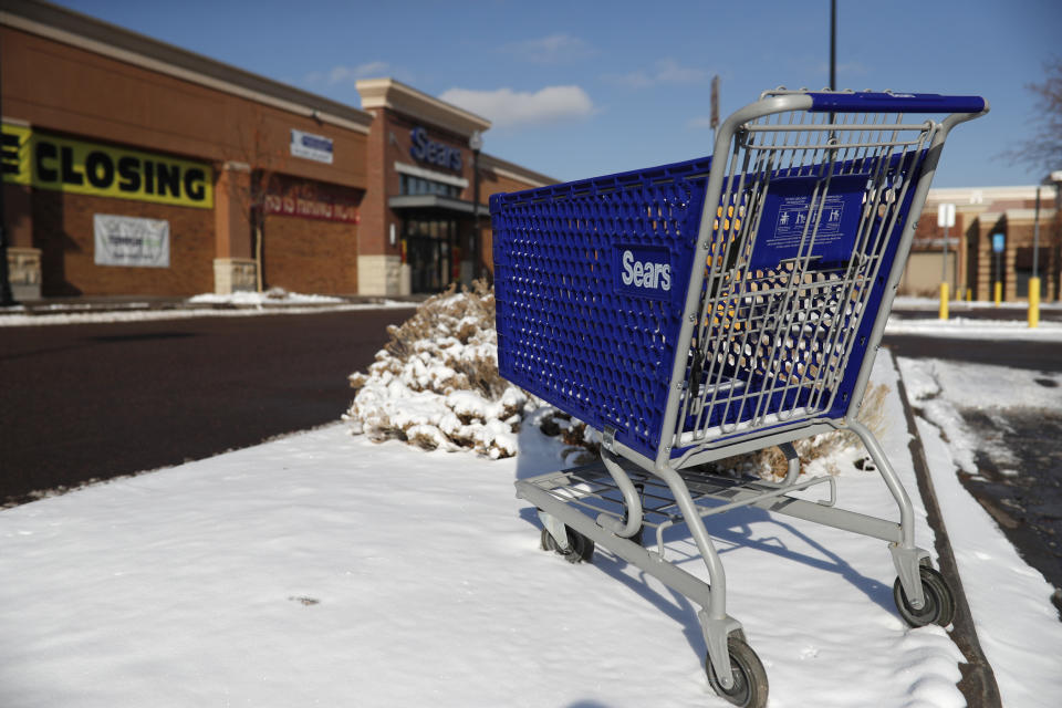 FILE - In this Jan. 1, 2019, file photo, an empty shopping cart sits outside a Sears store in the Streets of Southglenn mall in Littleton, Colo. Nine months out of bankruptcy, Sears is limping into the holiday shopping season. (AP Photo/David Zalubowski, File)