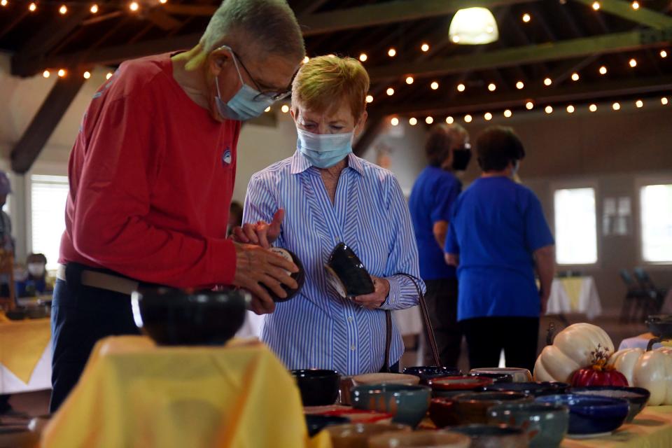 Bill and Nancy Curtis, of Vero Beach, look through the more than 1,200 handcrafted bowls on Thursday, Nov. 5, 2020, during the 28th annual Soup Bowl, Empty Bowls - Full Hearts sale at the Heritage Center in Vero Beach. In previous years, roughly 44 locations across the county would host a soup meal and sale of the bowls, but because of the COVID-19 pandemic, a one-day sale was held at the Heritage Center. "This year we cooked up something a little different," said Renee Bireley, program director and relationship manager with the Samaritan Center. "Because of the guidelines and challenges of COVID, we saw that we were not going to be able to have the event that we traditionally have." More than 1,200 bowls were made by artists at Indian River Clay and all proceeds will go to help the Samaritan Center.