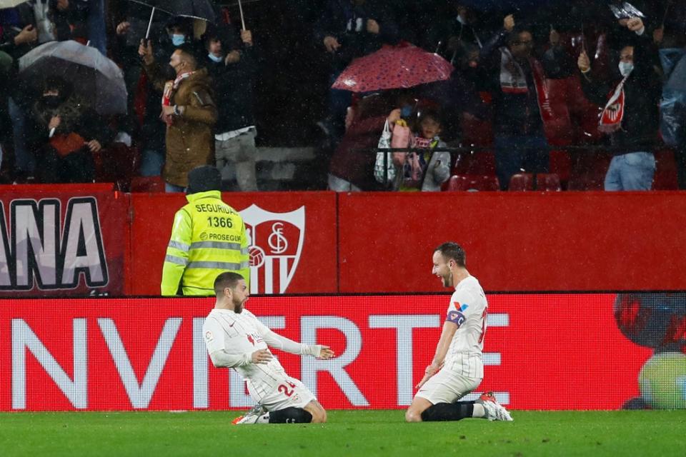 Sevilla’s Papu Gomez, left, celebrates with Ivan Rakitic after scoring the opening goal against Barcelona (Angel Fernandez/AP) (AP)