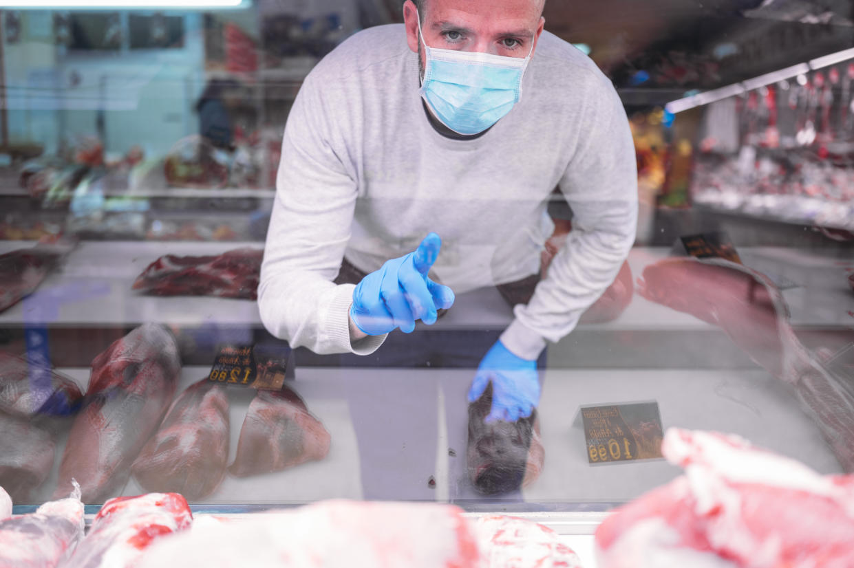 The man who wears a protective mask and gloves in the market