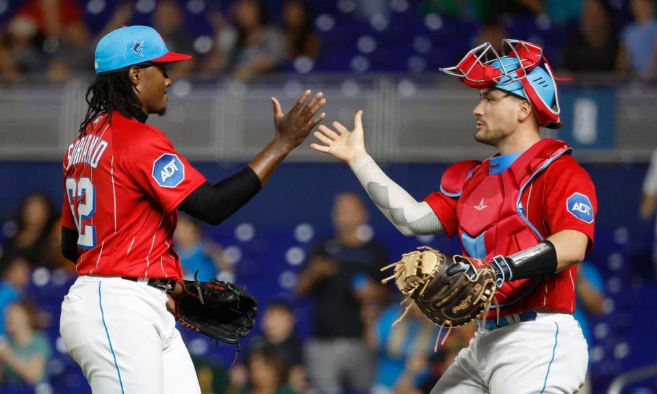 Jun 3, 2023; Miami, Florida, USA; Miami Marlins relief pitcher George Soriano (62) and catcher Nick Fortes (4) celebrate against the Oakland Athletics following the game at loanDepot Park. Mandatory Credit: Rhona Wise-USA TODAY Sports