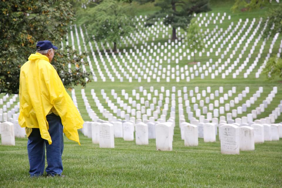 A veteran stares out into the sea of tombstones at the Arlington National Cemetery, April 27, 2024.