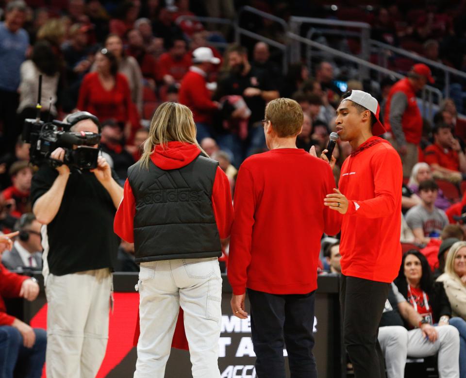 Allison Cook and Bruce Dougherty take turns emceeing U of L women's basketball games.