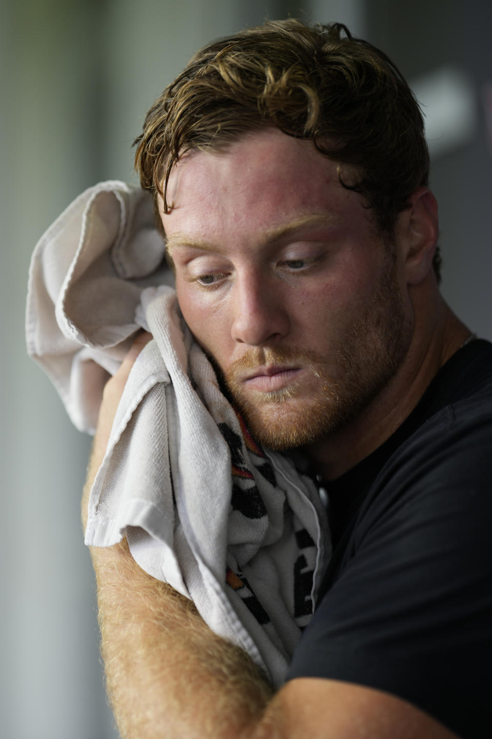 Tennessee Titans quarterback Will Levis wipes his face as he responds to questions during a news conference after NFL football practice Tuesday, June 4, 2024, in Nashville, Tenn. (AP Photo/George Walker IV)