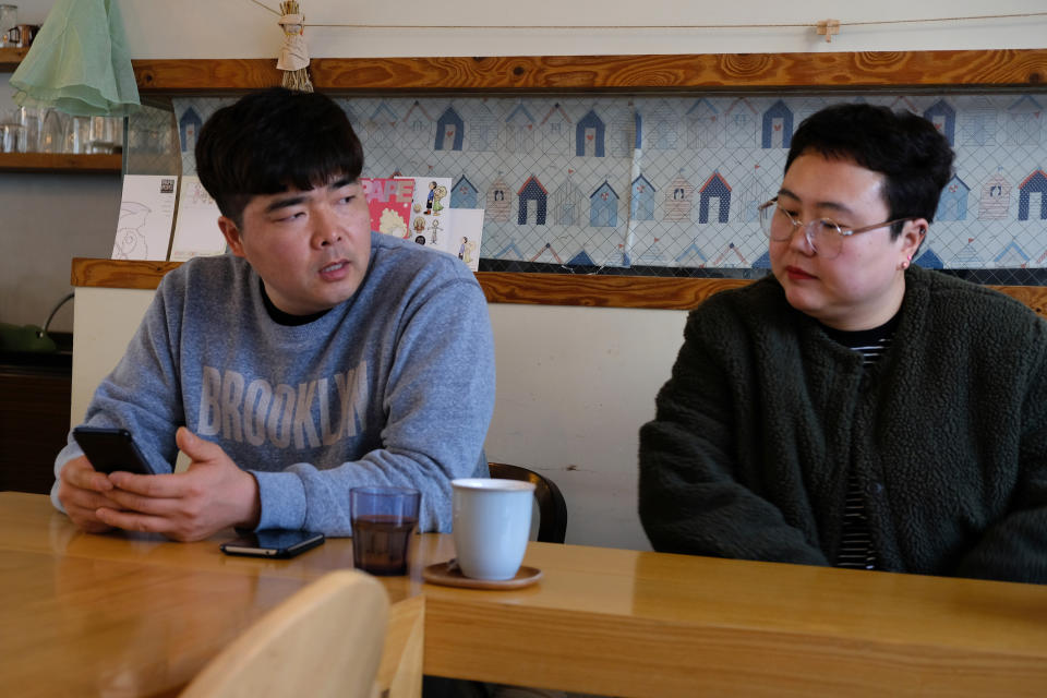 In this Wednesday, Feb. 19, 2020, photo, props manager Joo Dong-man, left, speaks as costume manager Yang Hee-hwa listens during an interview at a cafe in Ilsan, South Korea. South Korea's latest hit drama "Crash landing on you" portrays the fantastical story of a billionaire heiress accidentally paragliding into North Korea and falling in love with army captain. (AP Photo/Juwon Park)