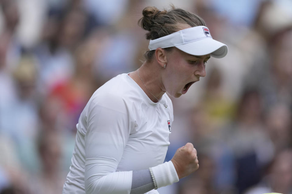 Barbora Krejcikova of the Czech Republic reacts after winning a game as she plays against Jasmine Paolini of Italy during the women's singles final at the Wimbledon tennis championships in London, Saturday, July 13, 2024. (AP Photo/Mosa'ab Elshamy)