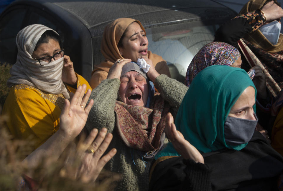 Relatives of Basharat Ahmad Zargar cry during his funeral in Srinagar, Indian-controlled Kashmir, Sunday, Feb.14, 2021. Zargar, who was working at a power project, was among the dozens killed after a part of a Himalayan glacier broke off on February 7 sending a devastating flood downriver slamming into two hydropower projects in northern India. (AP Photo/Mukhtar Khan)