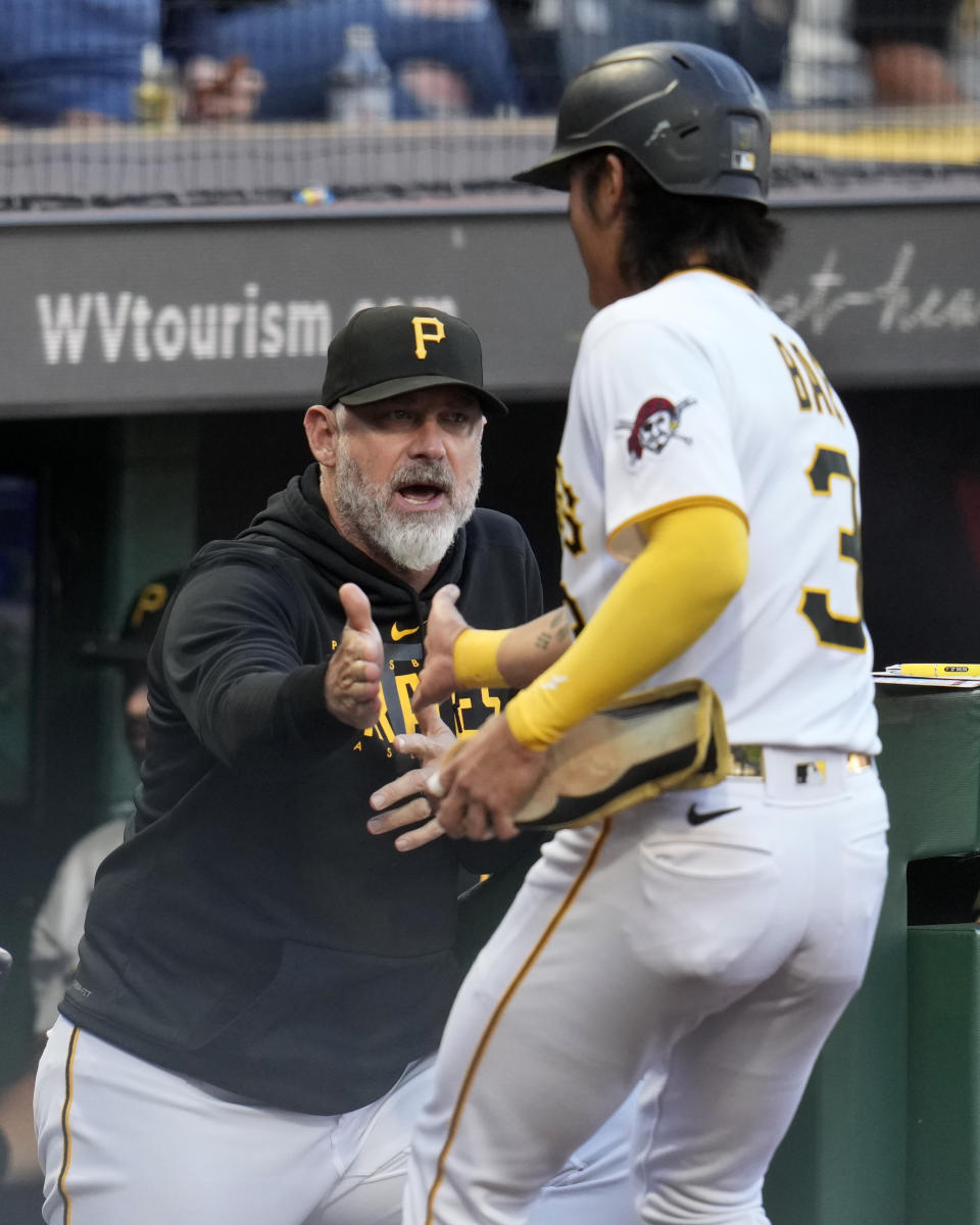 Pittsburgh Pirates manager Derek Shelton, left, greets Ji Hwan Bae as he returns to the dugout after scoring on a double by Ke'Bryan Hayes off Washington Nationals starting pitcher Jackson Rutledge during the first inning of a baseball game in Pittsburgh, Wednesday, Sept. 13, 2023. (AP Photo/Gene J. Puskar)