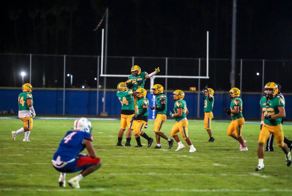 Coachella Valley players celebrate a fumble recovery ending a goal line drive by Indio during the fourth quarter of their game in Indio, Calif., Friday, Oct. 27, 2023.