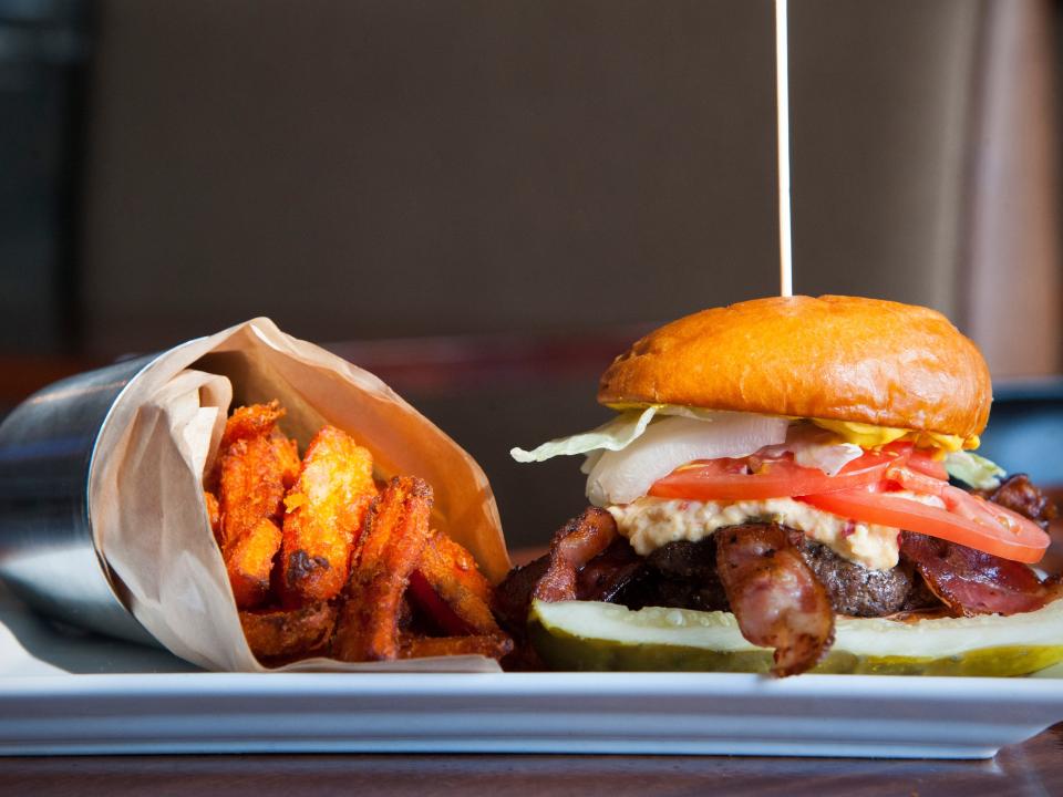 brioche burger and fries on a tray