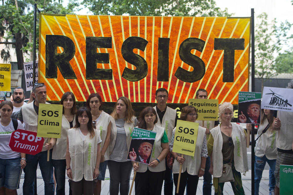 Greenpeace protesters stand outside the U.S. embassy in Madrid