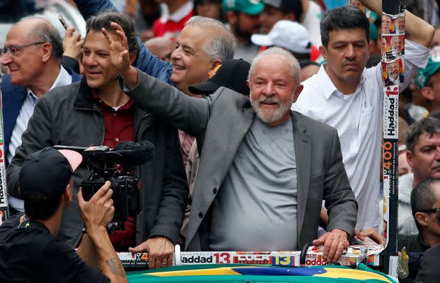 Brazil's former president and presidential candidate for the leftist Workers' Party , Luiz Inacio Lula da Silva (right), and Sao Paulo gubernatorial candidate Fernando Haddad (left) greet supporters during a campaign rally in Sao Paulo on Oct. 1, on the eve of the presidential election. (Photo: MIGUEL SCHINCARIOL via Getty Images)