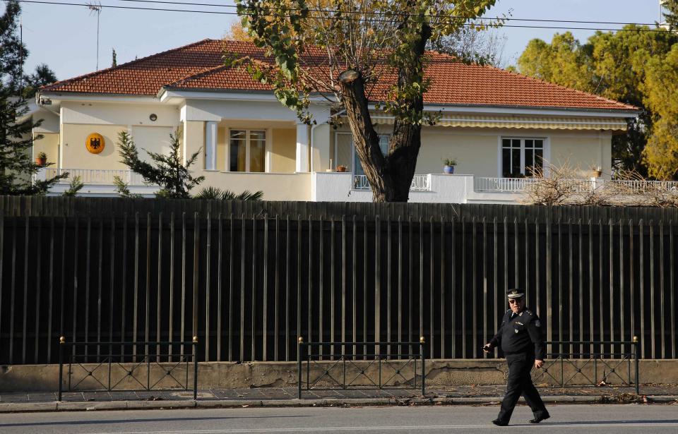 A police officer walks in front of the residence of German Ambassador in Greece, Wolfgang Dold, following an attack by unknown gunmen early December 30, 2013 in an Athens suburb. Unidentified assailants opened fire on the German ambassador's residence in Athens with a Kalashnikov assault rifle early on Monday in an attack seen as an attempt to sour relations between debt-laden Greece and its biggest creditor. REUTERS/Yannis Behrakis (GREECE - Tags: POLITICS CRIME LAW)