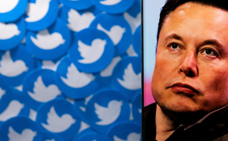 An image of Elon Musk is seen on a smartphone placed on printed Twitter logos in this picture illustration taken April 28, 2022. REUTERS/Dado Ruvic/Illustration