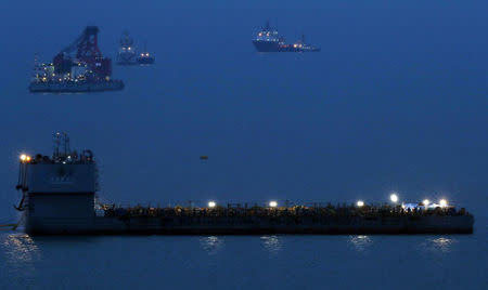 Barges are seen during a salvage operation of sunken ferry Sewol at the sea off Jindo, South Korea, March 22, 2017. Yonhap via REUTERS