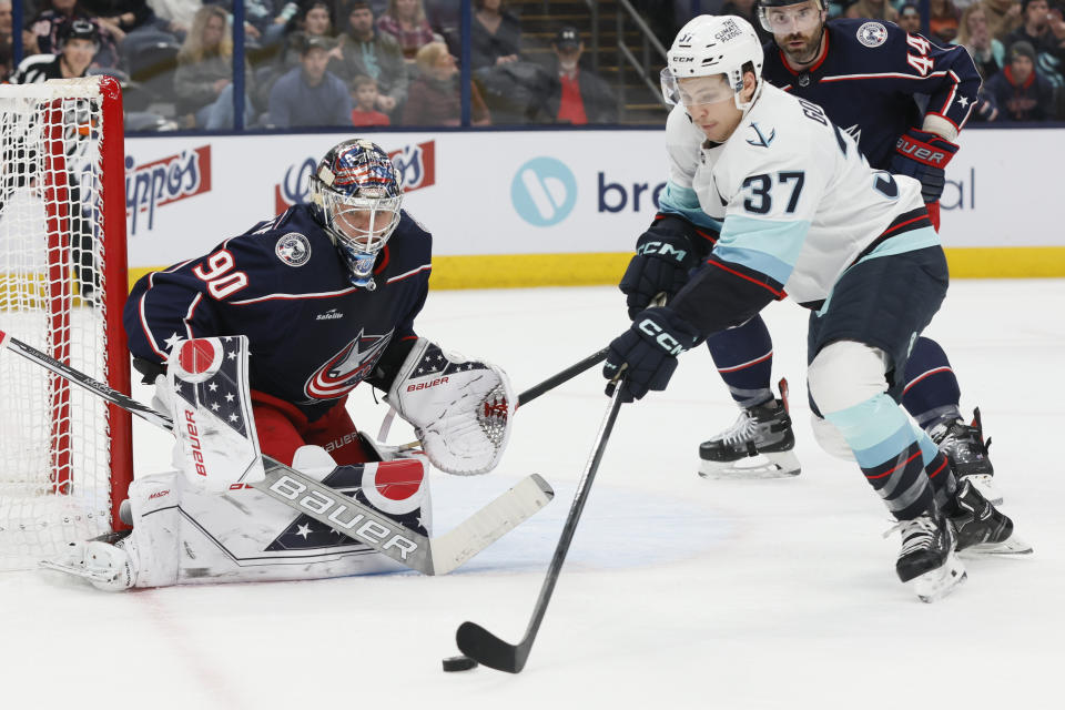Seattle Kraken's Yanni Gourde looks for a shot on Columbus Blue Jackets' Elvis Merzlikins during the first period of an NHL hockey game Friday, March 3, 2023, in Columbus, Ohio. (AP Photo/Jay LaPrete)