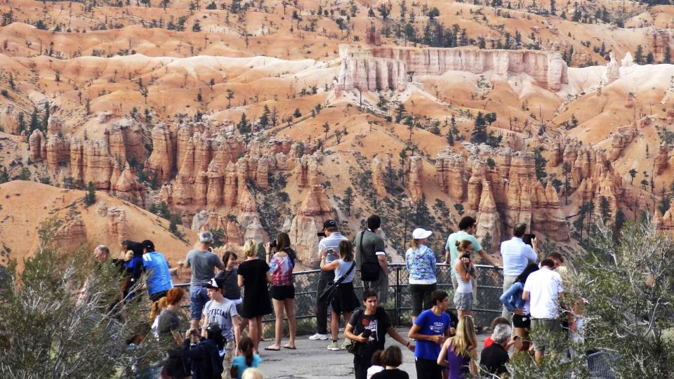 Visitors enjoy the view of the Bryce Canyon National Park, Utah in this file photo from August 19, 2012. Utah will reopen its national parks and monuments under a deal with the U.S. Department of the Interior, which closed the sites and other parks across the country as part of the partial federal government shutdown that began on Oct. 1. REUTERS/Charles Platiau/Files (UNITED STATES - Tags: ENVIRONMENT TRAVEL)
