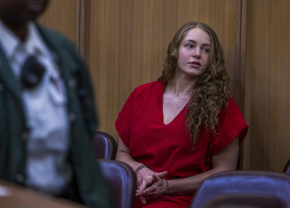 OnlyFans model Courtney Clenney sits in the courtroom during a hearing in front of Judge Laura Shearon Cruz, where the computer hacking charges against her and her parents, Deborah and Kim Clenney, were dismissed at the Gerstein Justice Building, Thursday, July 11, 2024, in Miami. Courtney Clenney is accused of stabbing to death her boyfriend in a Miami condo in 2022. The murder charge has not been dropped. (Pedro Portal/Miami Herald via AP)