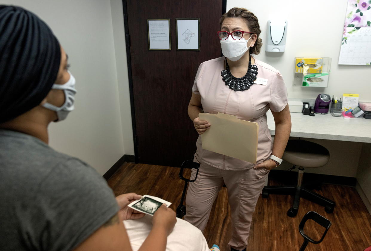 A nurse at Houston Women’s Reproductive Services speaks with a patient.