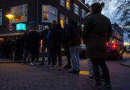 People queue to buy marijuana at the coffeeshop Bulwackie in Amsterdam, Netherlands, Sunday, March 15, 2020, after a TV address by health minister Bruno Bruins who ordered all Dutch schools, cafes, restaurants, coffeeshops and sport clubs to be closed on Sunday as the government sought to prevent the further spread of coronavirus in the Netherlands. For most people, the new coronavirus causes only mild or moderate symptoms, such as fever and cough. For some, especially older adults and people with existing health problems, it can cause more severe illness, including pneumonia. (AP Photo/Peter Dejong)