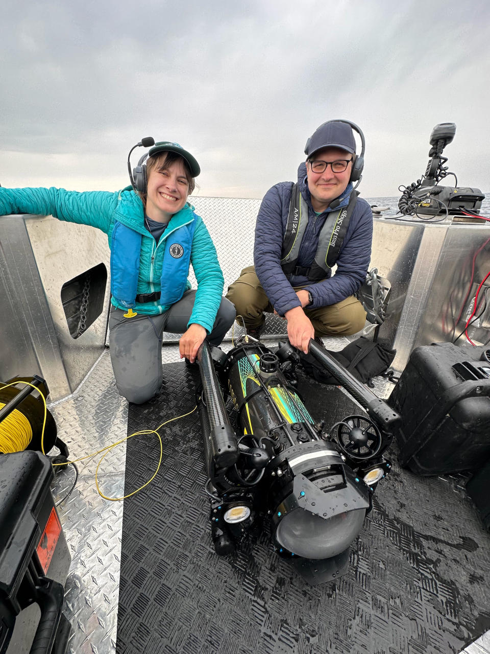 Yvonne Drebert (left), and Zach Melnick (right), moments after the discovery of the Africa, with their robot, Kiyi (center). / Credit: Esme Batten.