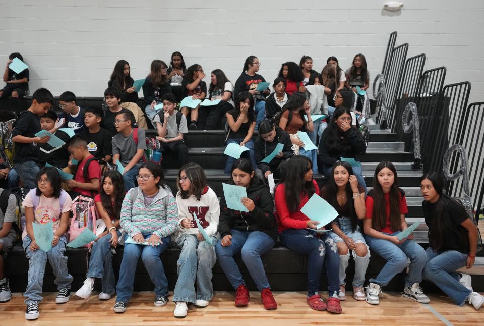 Students check out their class schedules as they arrive Wednesday at Del Valle Middle School.