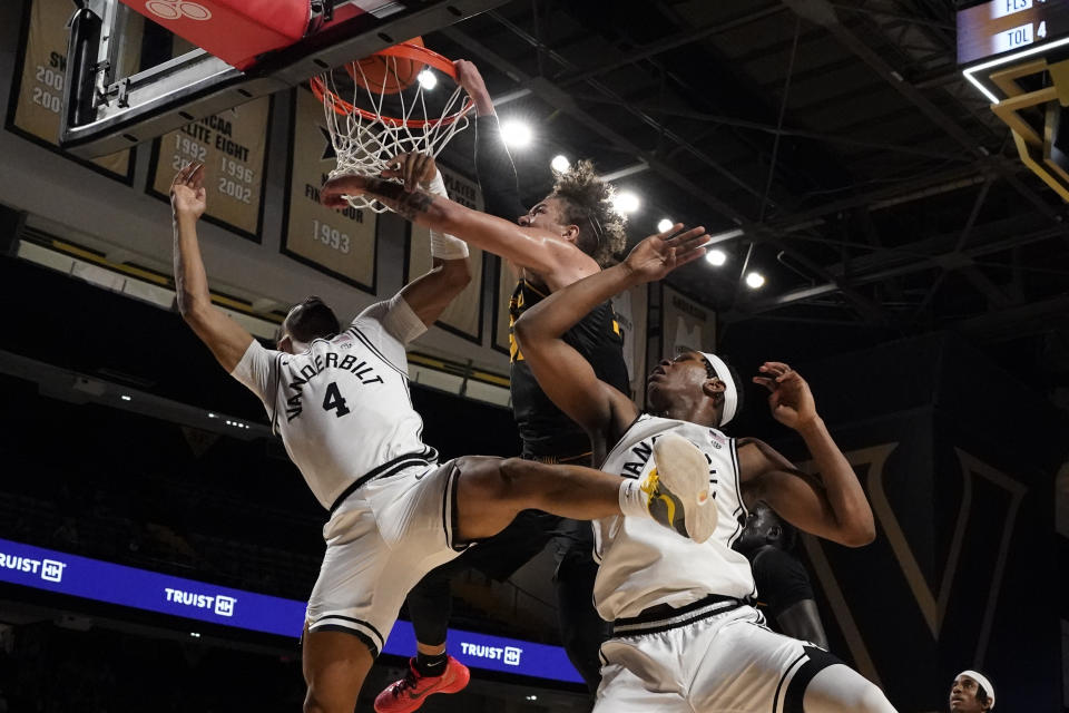 Missouri forward Noah Carter, center, is fouled as he shoots past Vanderbilt guard Isaiah West (4) and forward Ven-Allen Lubin, right, during the first half of an NCAA college basketball game Saturday, Feb. 3, 2024, in Nashville, Tenn. (AP Photo/George Walker IV)