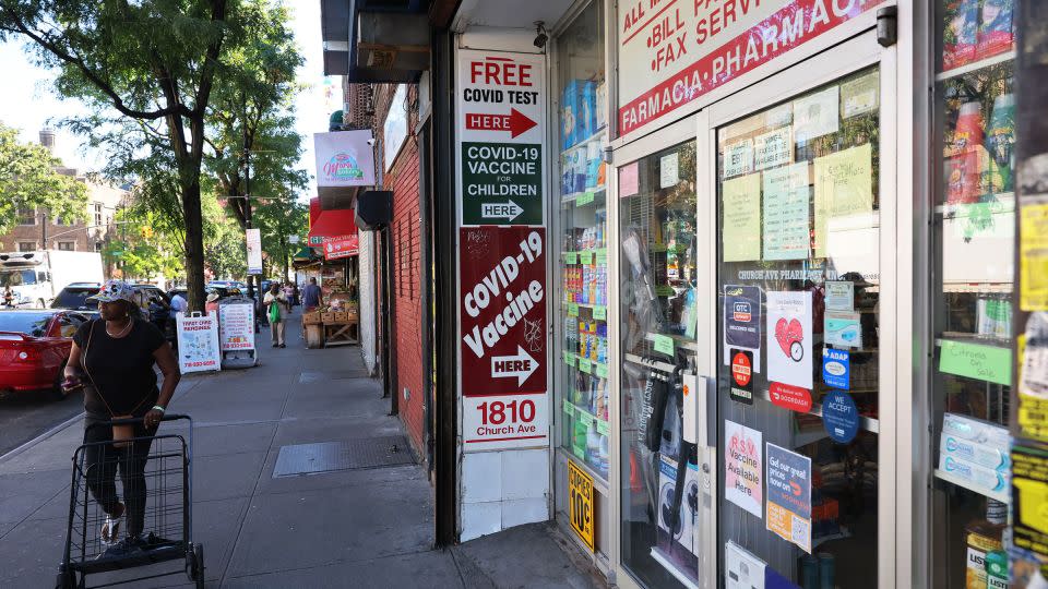 A sign for Covid-19 vaccines is seen on a door of a pharmacy in September 2023 in New York City. - Michael M. Santiago/Getty Images