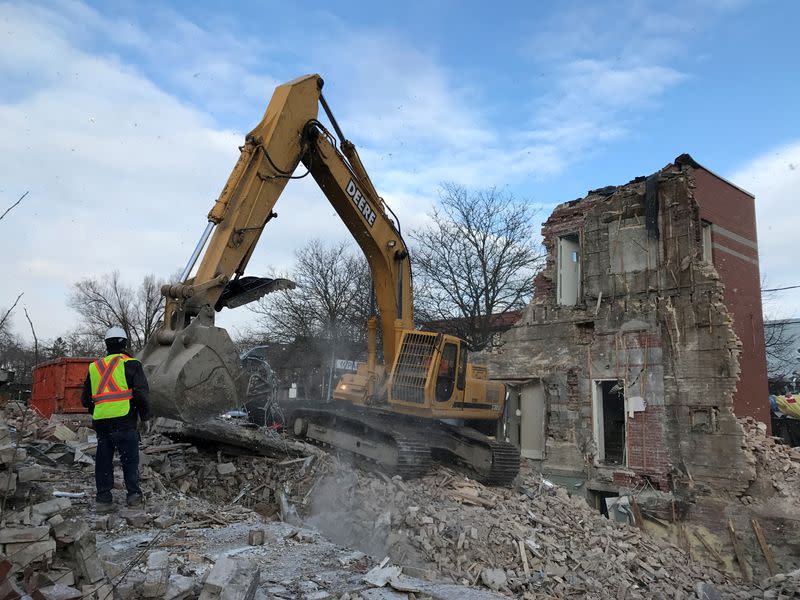 FILE PHOTO: Construction equipment digs through the remains of a 110-year old Bank of Montreal building in Toronto