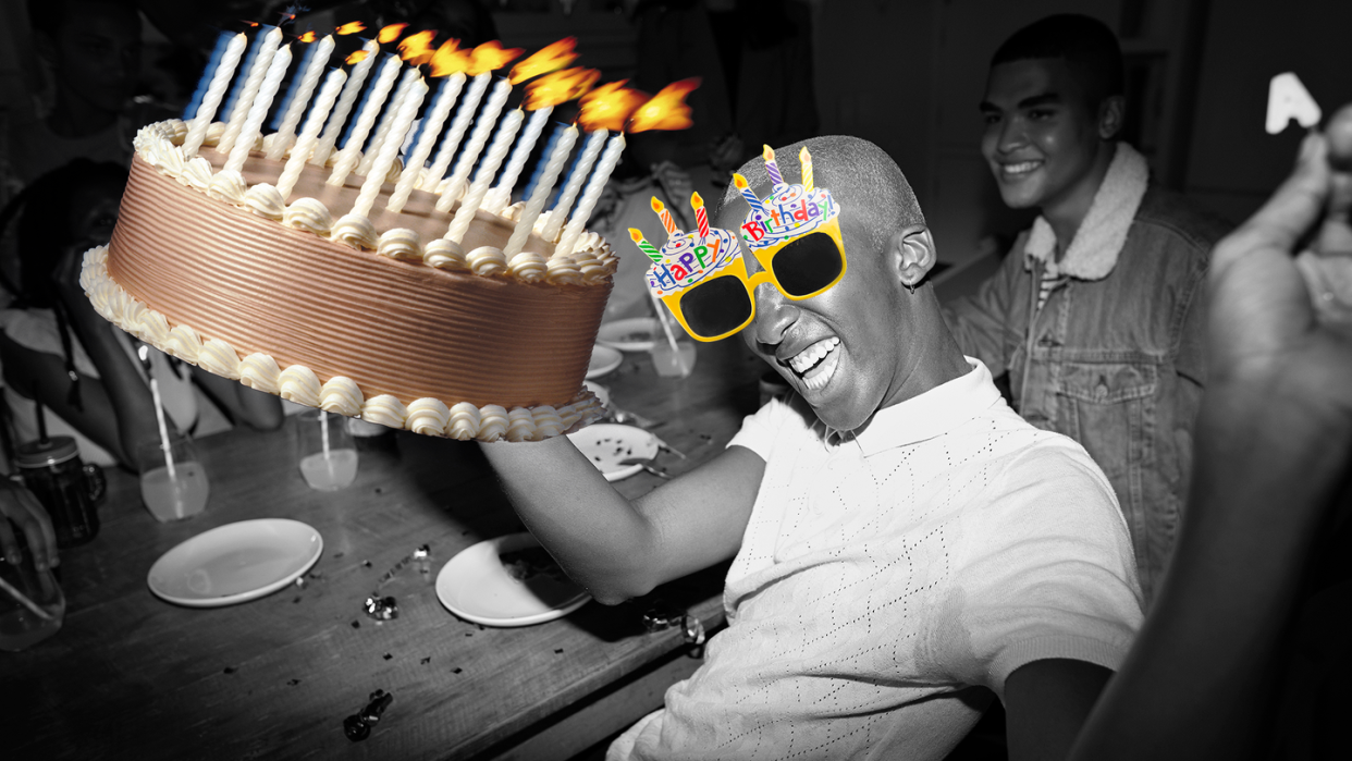 man holding cake with birthday glasses