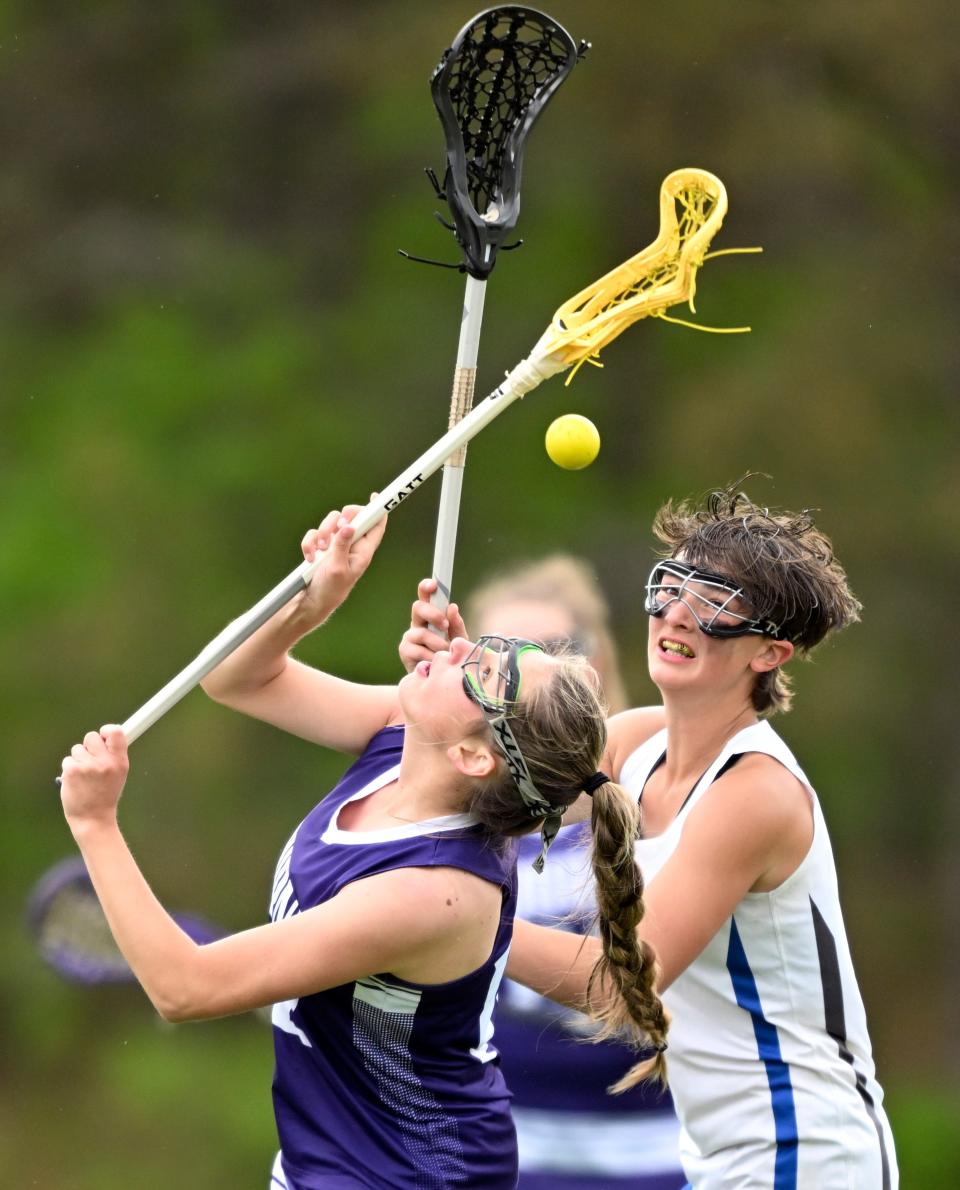 Madigan Kelley of Bourne and Adryanna Turner of Upper Cape Tech watch the ball fly free.