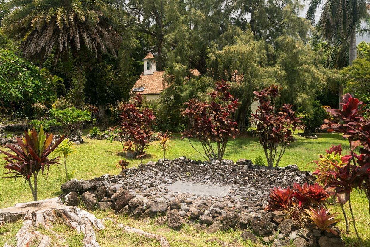 Grave of aviator Charles Lindbergh in the Cemetery of Palapala Ho'omau Church near Hana, Hawaii on a cloudy tropical day