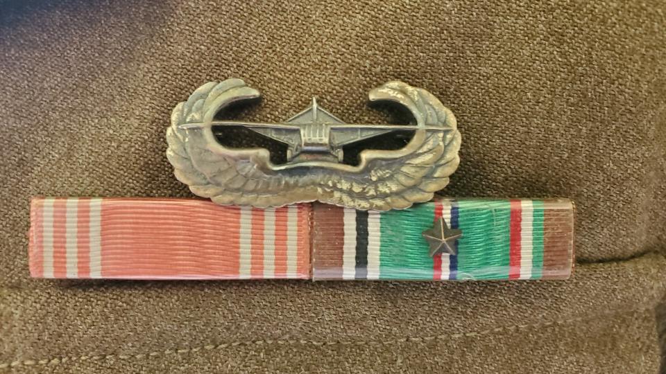 The glider badge, along with a good conduct medal (left) and a European–African–Middle Eastern Campaign Medal (reversed) on Sgt. Charles J. Schoepf's uniform.