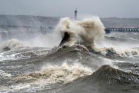 Waves crash into the wall at Newhaven in East Sussex. (PA)