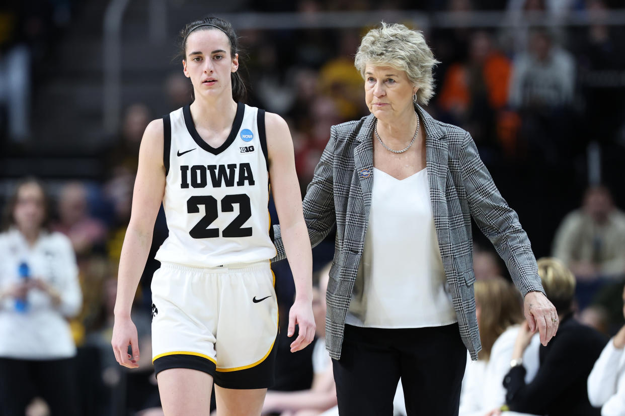 Iowa's Caitlin Clark walks with head coach Lisa Bluder during Saturday's win. (Scott Taetsch/Getty Images)