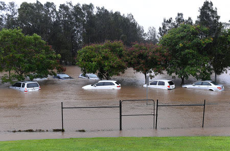 Cars sit submerged after heavy rain associated with Cyclone Debbie hit the Gold Coast suburb of Robina in Queensland, Australia, March 30, 2017. AAP/Dave Hunt/via REUTERS