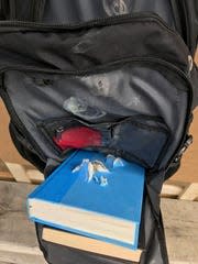 Hardcover books, placed inside a bulletproof backpack but outside the pack’s protective Kevlar shell, torn to shreds by ammunition of different caliber.