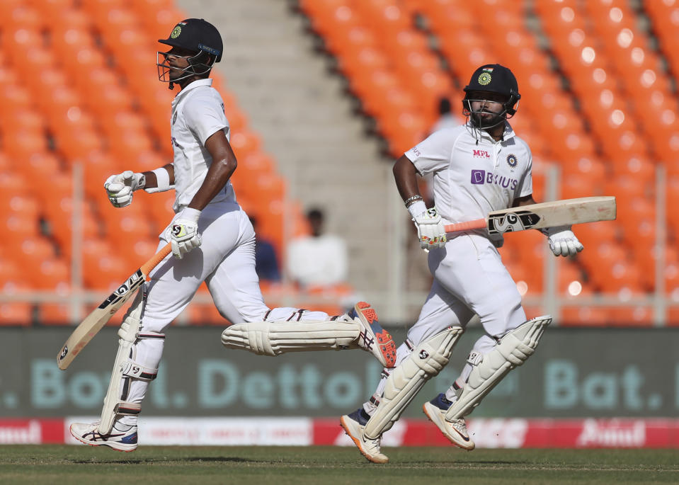 India's Rishabh Pant, right, and Washington Sundar run between the wickets to score during the second day of fourth cricket test match between India and England at Narendra Modi Stadium in Ahmedabad, India, Friday, March 5, 2021. (AP Photo/Aijaz Rahi)