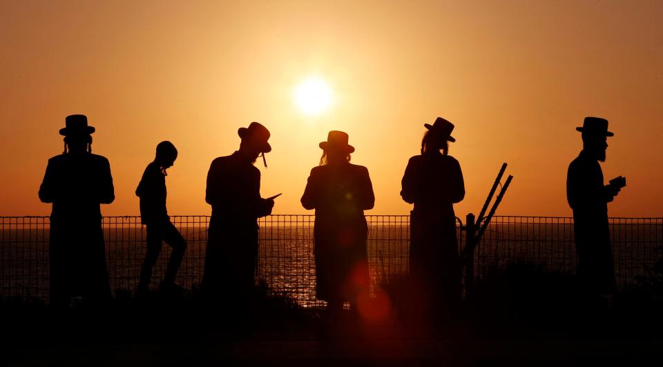 Ultra-Orthodox Jewish men and children perform the "Tashlich" ritual in the coastal city of Netanya on September 14, 2021.