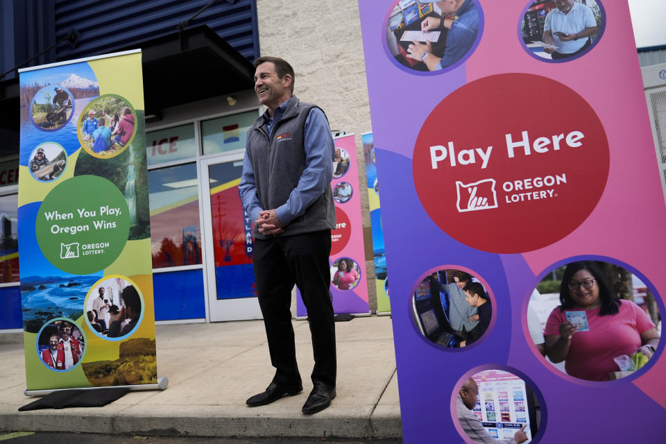 Plaid Pantry President and CEO Jonathan Polonsky laughs during a news conference outside a Plaid Pantry convenience store on Tuesday, April 9, 2024, in Portland, Ore. A ticket matching all six Powerball numbers in Saturday's $1.3 billion jackpot was sold at the store. (AP Photo/Jenny Kane)