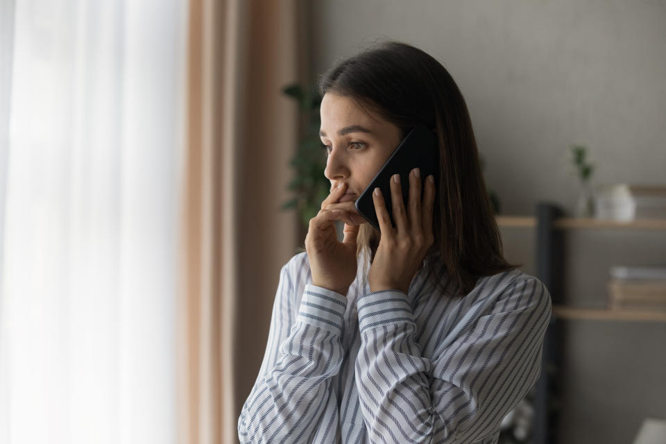 Sad millennial woman has difficult phone talk hold gadget by ear listen to unexpected bad news think on answer. Compassionate young lady support friend by cell try to help ponder on advice. Copy space