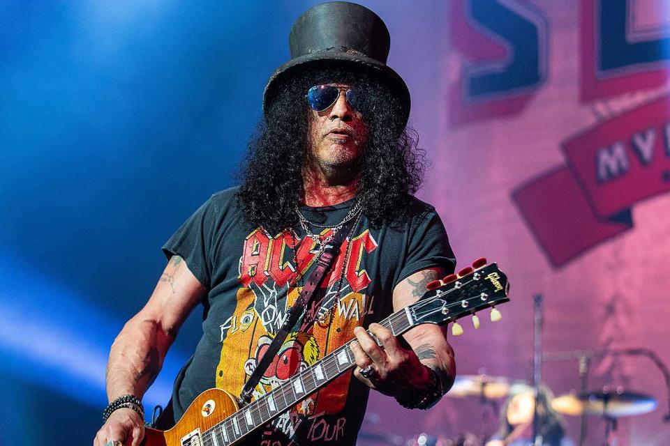 <p>Mat Hayward/Getty</p> Slash performs at the Paramount Theatre on Feb. 9, 2022 in Seattle, Washington