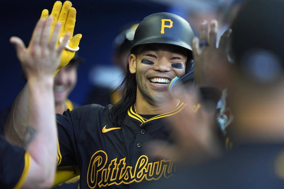 Pittsburgh Pirates' Connor Joe is congratulated by teammates after he scored on a single by Ke'Bryan Hayes, during the fourth inning of a baseball game against the Miami Marlins, Saturday, March 30, 2024, in Miami. (AP Photo/Wilfredo Lee)