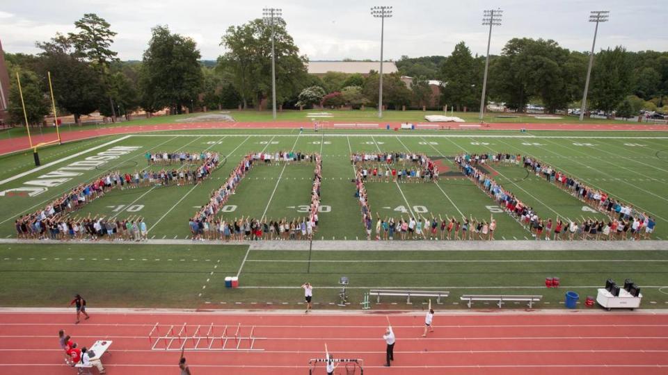 Davidson College Class of 2020 graduates gathered on the school football field their first year at Davidson for their class photo.