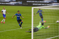 Inter Milan's Lautaro Martinez, second from left, scores his side's second goal past Sampdoria's goalkeeper Emil Audero during the Serie A soccer match between Inter Milan and Sampdoria at the San Siro Stadium, in Milan, Italy, Sunday, June 21, 2020. (AP Photo/Antonio Calanni)