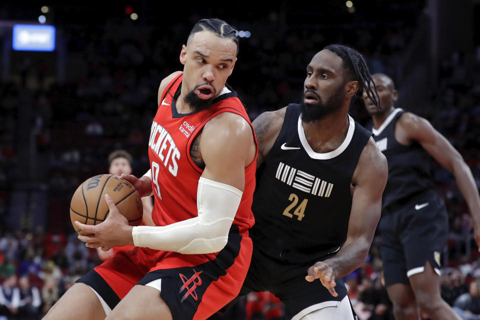 Houston Rockets forward Dillon Brooks, left, looks to drive around Memphis Grizzlies guard Jaylen Nowell (24) during the first half of an NBA basketball game Wednesday, Dec. 13, 2023, in Houston. (AP Photo/Michael Wyke)