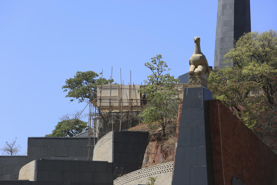 Construction of a mausoleum where former Zimbabwean President Robert Mugabe was supposed to be buried continues at the National Heroes Acre, in Harare, Friday, Sept, 27, 2019. Zimbabwe's former president Mugabe will now be buried at his rural home, according to a government spokesperson. Mugabe's burial location has been a source of mystery and contention since his death earlier this month at age 95 in Singapore. (AP Photo/Tsvangirayi Mukwazhi)