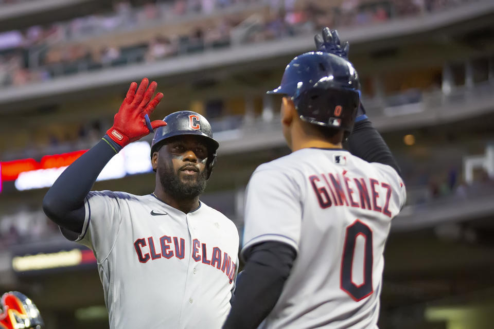 Cleveland Guardians' Franmil Reyes, left, is congratulated by Guardians' Andres Gimenez (0) after hitting a two-run homer against the Minnesota Twins in the eighth inning of a baseball game Tuesday, June 21, 2022, in Minneapolis. (AP Photo/Andy Clayton-King)