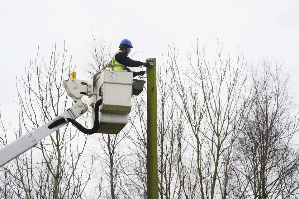 ESB Network technician Chris Doherty works to restore power at the site of a fallen tree in Kilcock, Co Kildare (Brian Lawless/PA) (PA Wire)